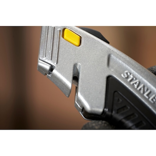 STANLEY 0-10-788 utility knife close-up showing blade area and yellow button.