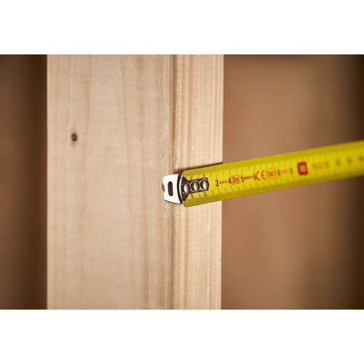 STANLEY 0-33-522 tape measure extended against light wood, close-up photography.