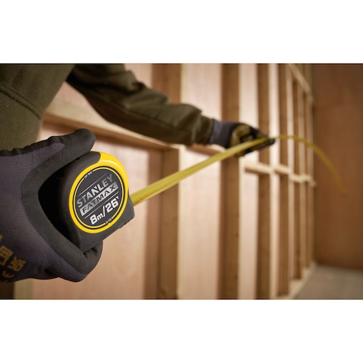 Photo of STANLEY 0-33-726 FATMAX tape measure being used to measure wooden frame.