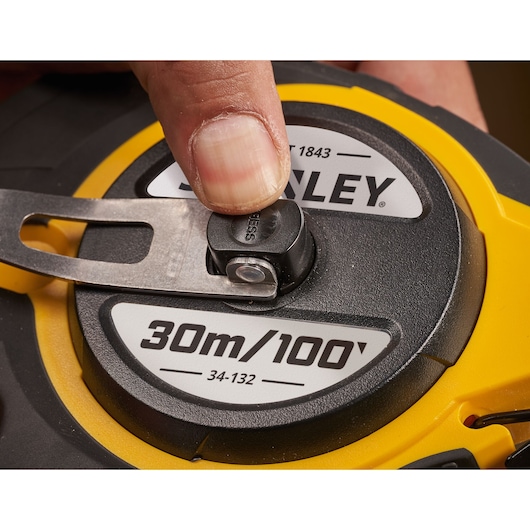STANLEY 0-34-132 FatMax tape measure photography, black and yellow casing, rugged construction, side angle.