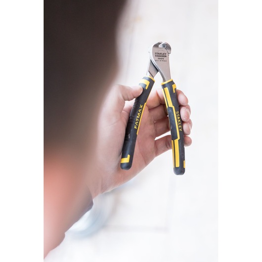 Photo of STANLEY 0-89-875 FATMAX end cutting pliers with black and yellow handles held in a hand.
