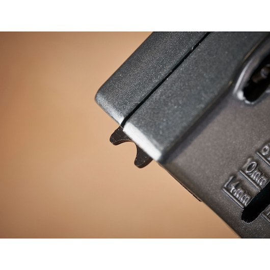 STANLEY 0-TR250 photography of black stapler front detail, showing metal guide on beige background.