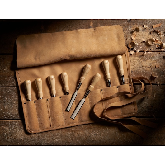 STANLEY 1-16-793 chisel set in tan leather roll, photographed from above on rustic wood.