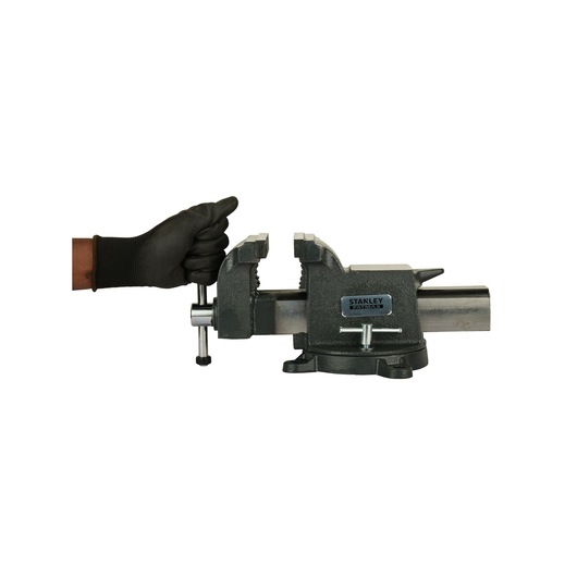 Photo of STANLEY 83-067 bench vise on white background, gloved hand turning handle.