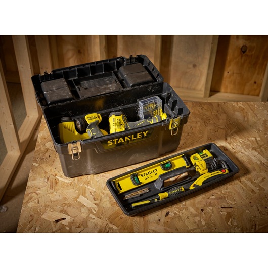 STANLEY 1-94-858 tool box with yellow hand tools and tray, angled view on wooden surface.