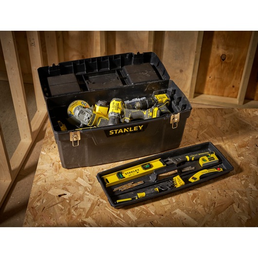 STANLEY 1-94-859 black toolbox with yellow tools on work surface, photography category, front angle.