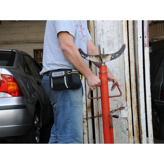 STANLEY 1-96-179 tool pouch worn on waist, photo of pouch in garage setting.