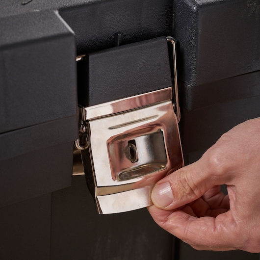 STANLEY 1-97-503 metal latch on black toolbox, close-up angle, hand opening latch.