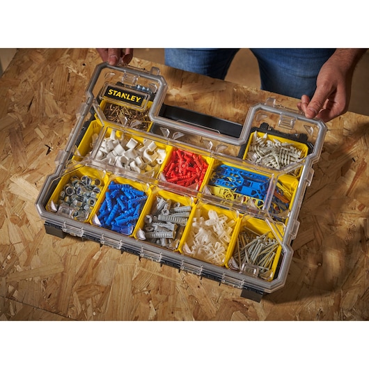 STANLEY 1-97-517 organiser with transparent lid, yellow compartments, assorted wall plugs and hardware.