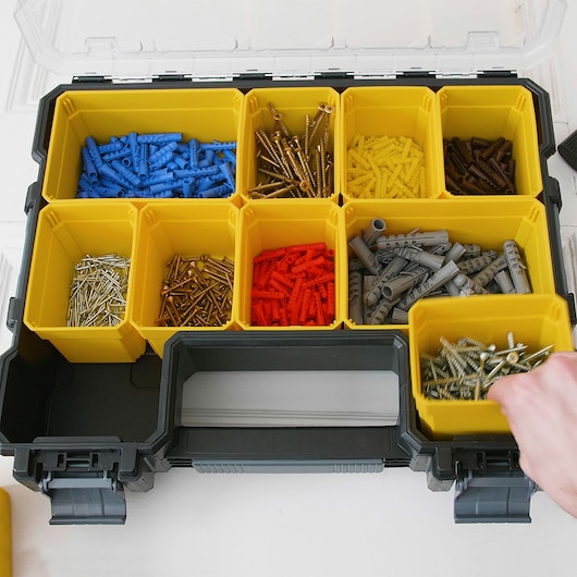 STANLEY 22910 organizer photography, yellow compartments with assorted screws and wall plugs, top view.