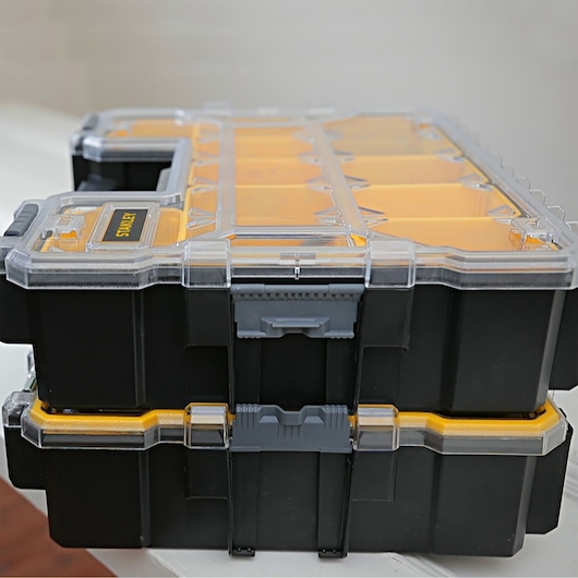 STANLEY 22910 black and yellow stackable organizer box, side view, with clear plastic lid and secure latches.