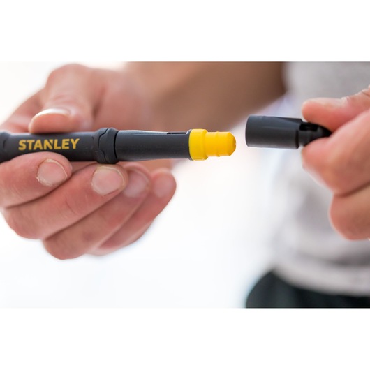 STANLEY 66-344M screwdriver with yellow interchangeable tip held in hand, close-up photography.