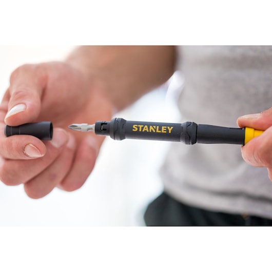 Photo of STANLEY 66-344M black and yellow screwdriver being held in hand, cap removed.