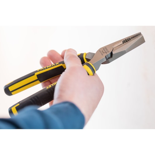 STANLEY 89-868 pliers with black and yellow handles held in hand, close-up view, FATMAX branding visible.