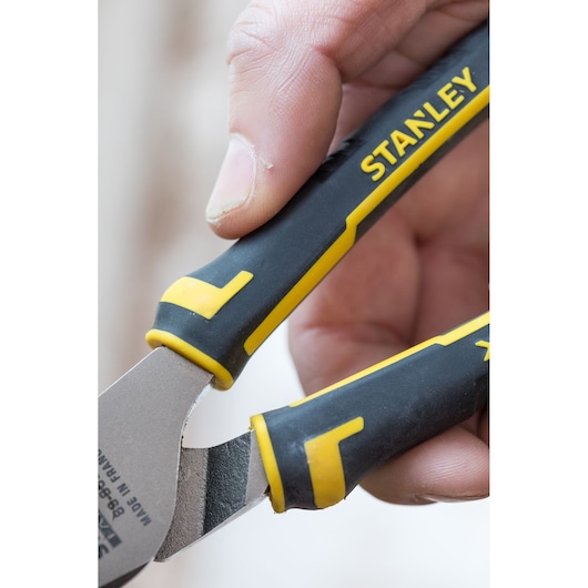 Close-up photo of STANLEY 89-868 cutting pliers with black and yellow handles held in hand.