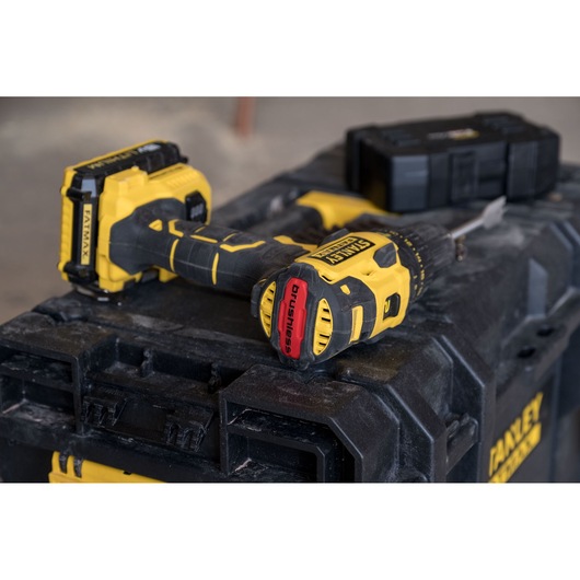 STANLEY FMC607D2 cordless drill photographed on a rugged black toolbox, yellow and black design.