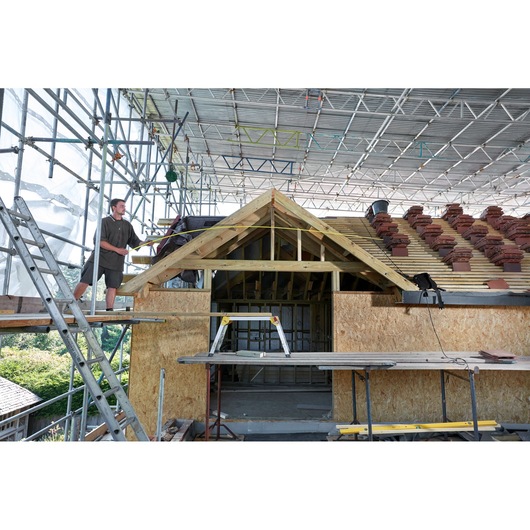 STANLEY FMHT0-36326 photography of construction site with scaffolding and roof building, wide angle view.