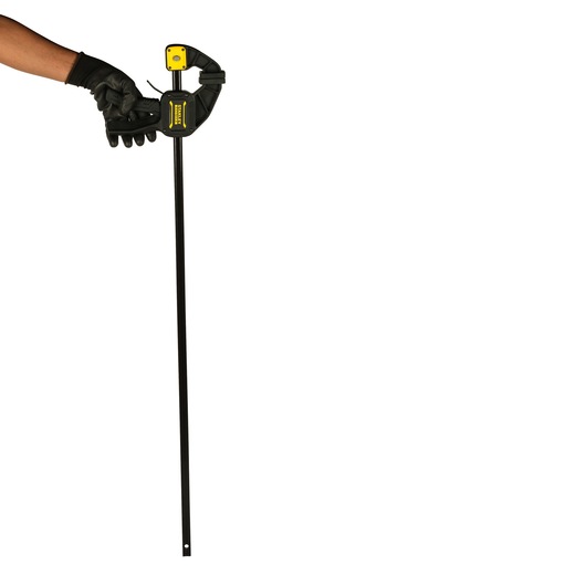Photo of STANLEY FMHT0-83237 bar clamp held by a gloved hand, black and yellow clamp, front angle.