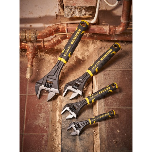 Photo of STANLEY FMHT13128-0 adjustable wrenches set with black and yellow handles on tiles.