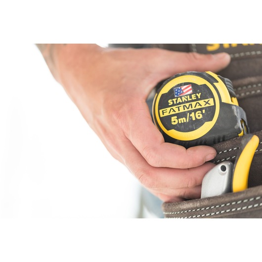 Photo of STANLEY FMHT36317-0 FATMAX 5m/16' tape measure held in a tool belt pouch.