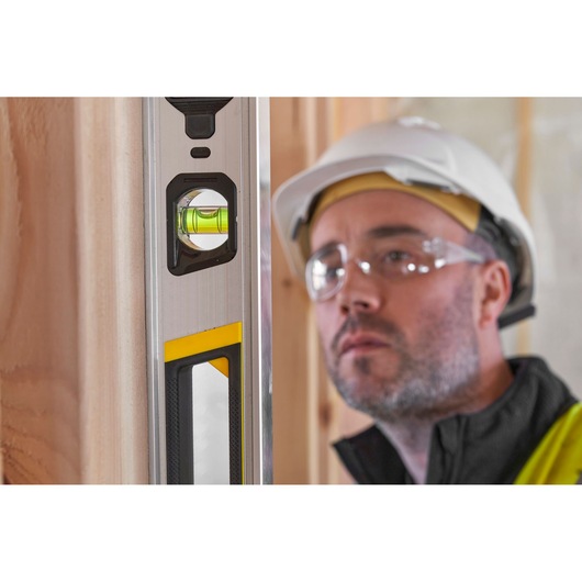 STANLEY FMHT43676-1 spirit level close-up, vertical angle, silver and yellow accents.