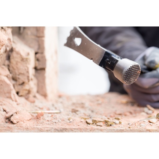 Stanley FMHT51367-2 hammer photography showing the textured striking face near bricks.