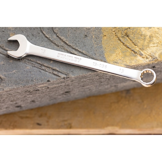 STANLEY FMMT13033-0 combination wrench, silver finish, photographed on concrete surface.