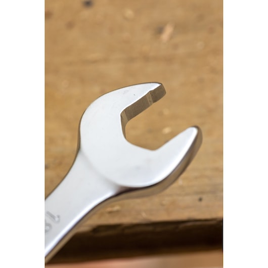 STANLEY FMMT13034-0 open-end wrench close-up on a wooden surface, silver finish, hand tool.