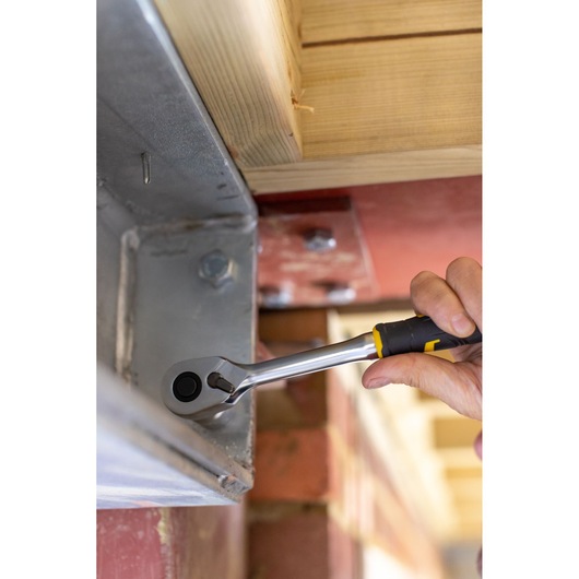 STANLEY FMMT82677-0 ratchet wrench used on metal beam, close-up action shot.