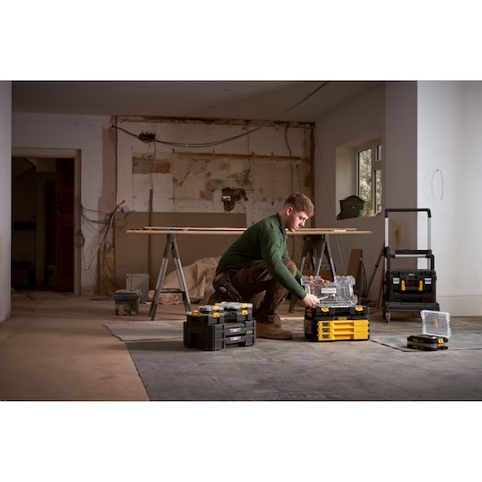 STANLEY FMMT98101-0 tool storage boxes stacked with organizer, shown in a workshop setting.