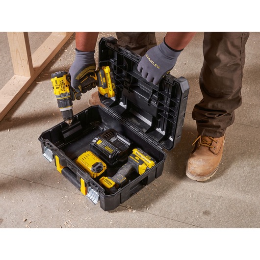 STANLEY FMST1-71966 black and yellow toolbox open with power tools and accessories, photo of top view on worksite.