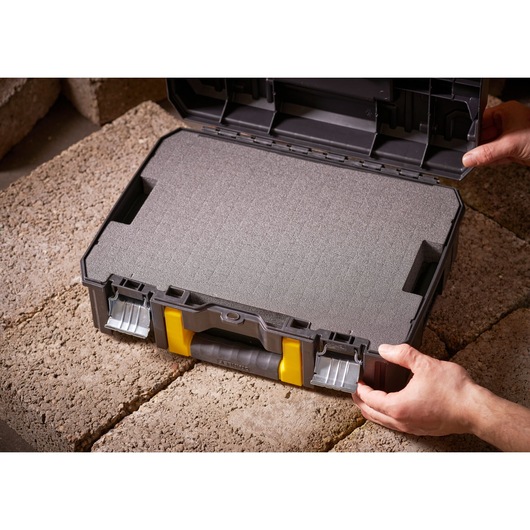 STANLEY FMST1-75502 foam-filled black tool case with yellow accents, open, shown on stone surface.