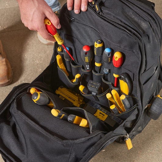 STANLEY FMST1-80144 tool backpack with organized hand tools in black and yellow, top view photo.