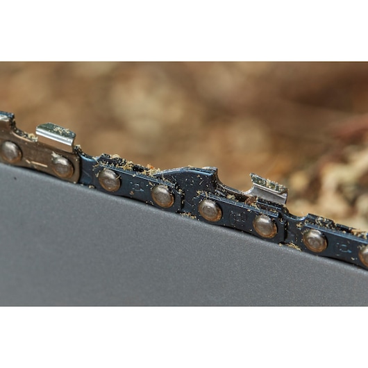 STANLEY SFMCCS630M1 chainsaw blade close-up showing metal teeth and sawdust.