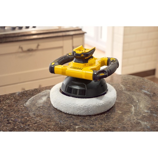 STANLEY SFMCE100D2 cordless polisher with black and yellow body on a kitchen countertop.