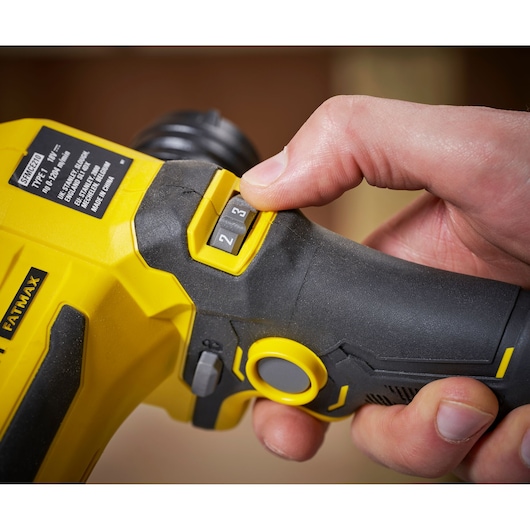 STANLEY SFMCE210B power tool close-up showing speed selector switch being adjusted by hand.