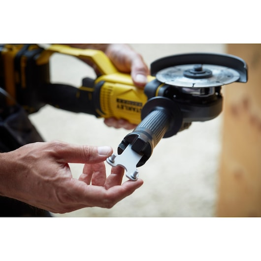 STANLEY SFMCG400M1K angle grinder with tool in hand, close-up photography of yellow and black power tool.