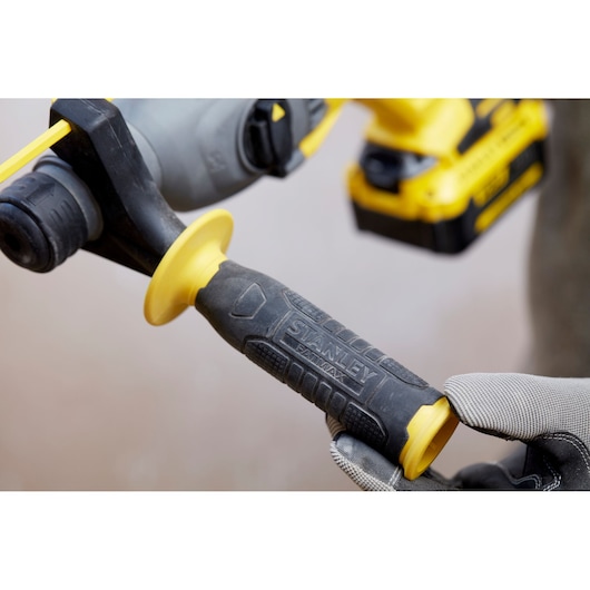 Photo of STANLEY SFMCH900M12 power tool handle with textured black and yellow grip, close-up side angle.
