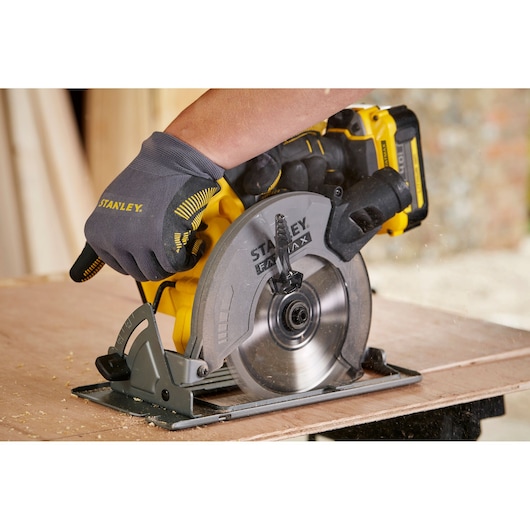 Stanley SFMCS500M1K cordless circular saw cutting wood, close-up photography of tool in use.