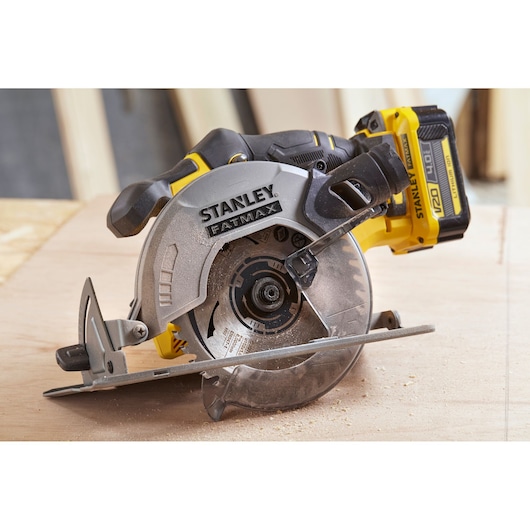 STANLEY SFMCS500M1K cordless circular saw, FATMAX series, yellow and black side view on wood.