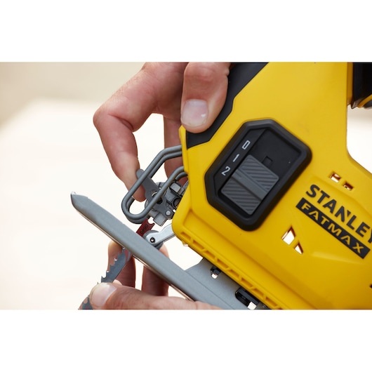 Close-up of STANLEY SFMCS600M1K jigsaw, showing blade installation and speed control switch.