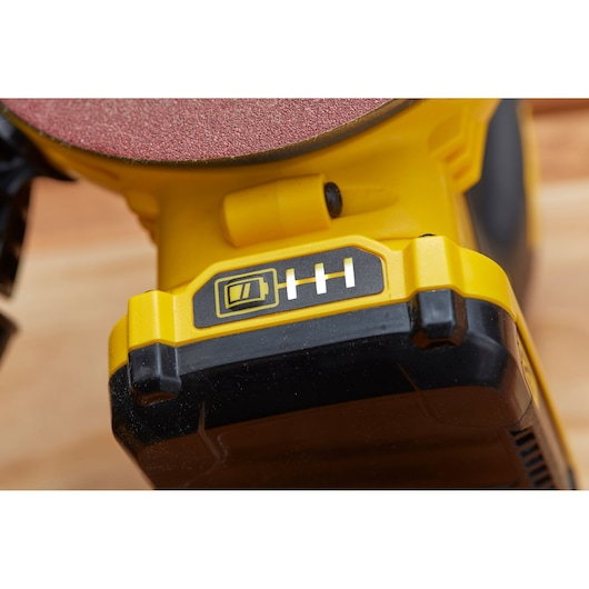 STANLEY SFMCW220D1S cordless sander battery indicator close-up, yellow and black body, photography.