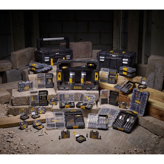 STANLEY STA88560 drill and bit set photography with multiple cases and tools on construction site.