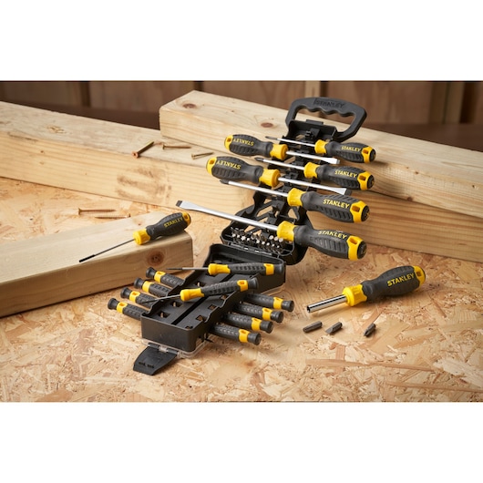 STANLEY STHT0-62144 screwdriver and bit set on wood surface, black and yellow handles, open case.