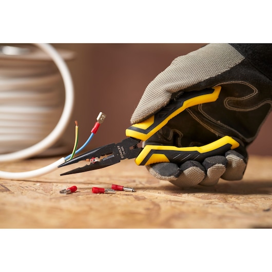 STANLEY STHT0-74363 wire stripper pliers with yellow-black handle in use, close-up on wiring task.