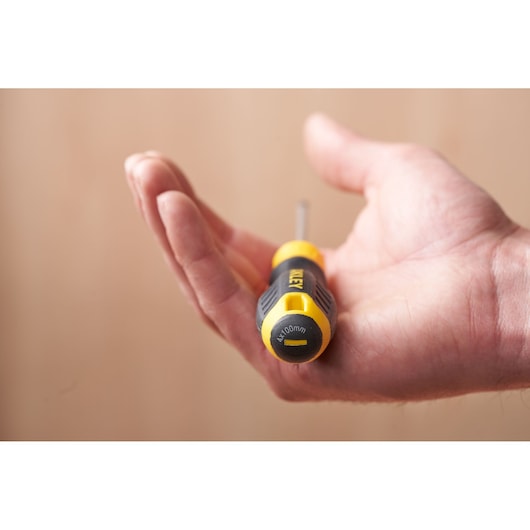Photo of STANLEY STHT16195-0 screwdriver held in hand, black and yellow handle visible.