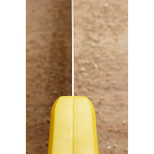 STANLEY STHT20372-1 handsaw close-up, straight-on angle, yellow handle and visible blade cutting wood.
