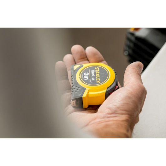 STANLEY STHT36806-0 yellow and black tape measure, 3m, held in a hand, close-up photo.