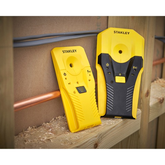 STANLEY STHT77587-0 stud finder with yellow and black finish, shown detecting wires and pipes