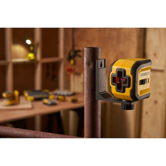 STANLEY STHT77611-0 laser level mounted on a metal pipe in a workshop setting.